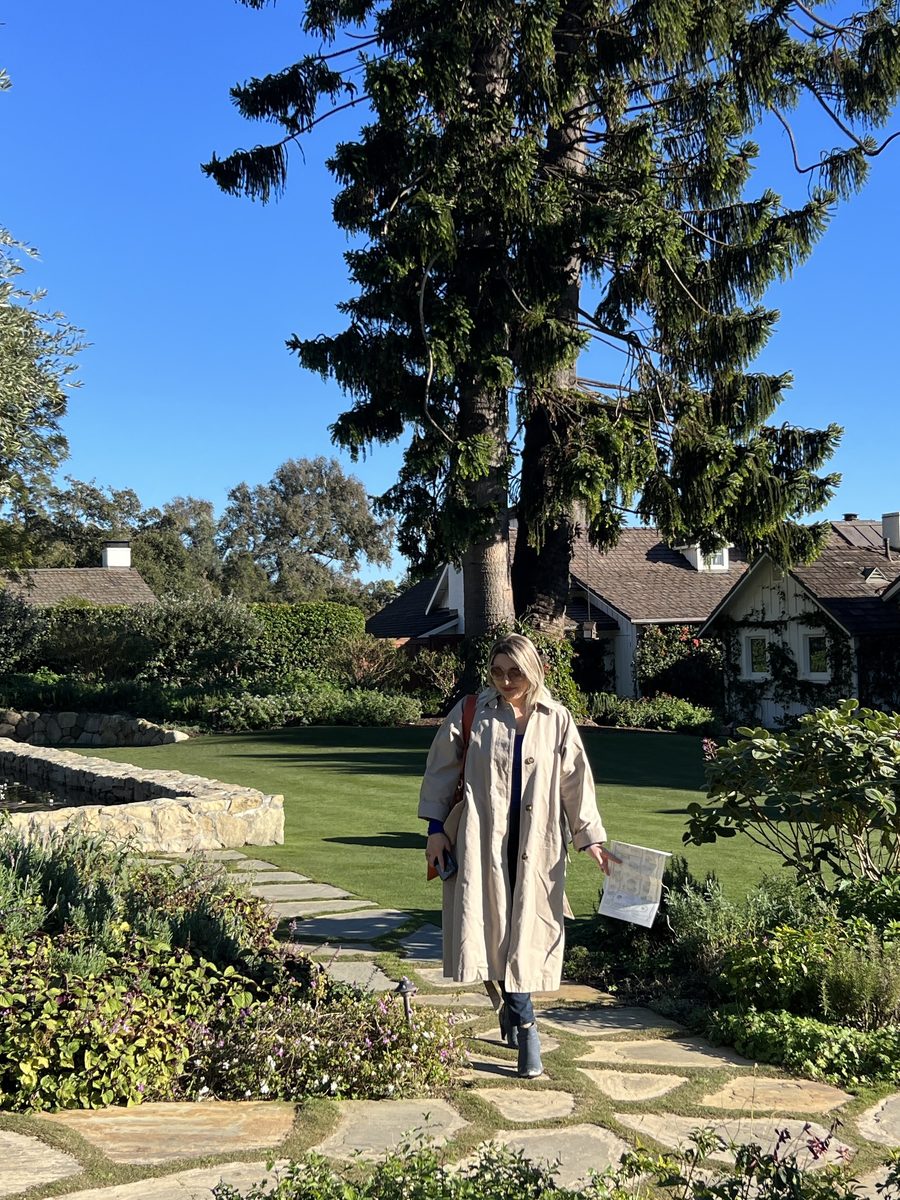 Delfina Alden walking a garden path